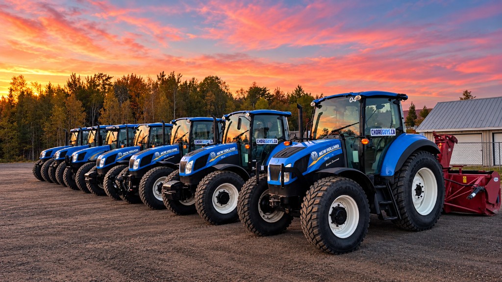 Choreguys New Holland tractors lined up in the yard at sunset